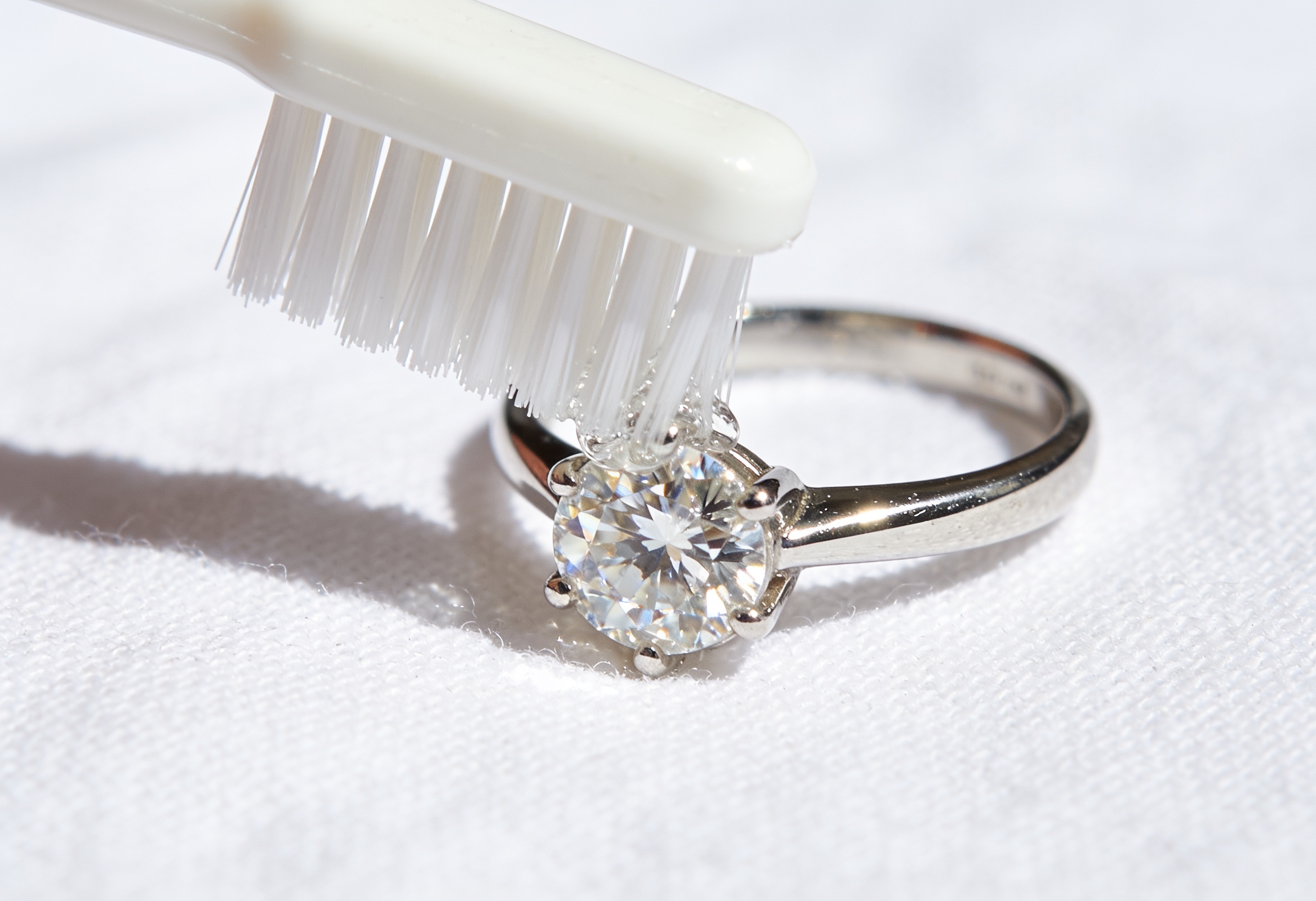 How to Clean a Diamond Ring 2 Soft toothbrush gently cleaning a diamond engagement ring