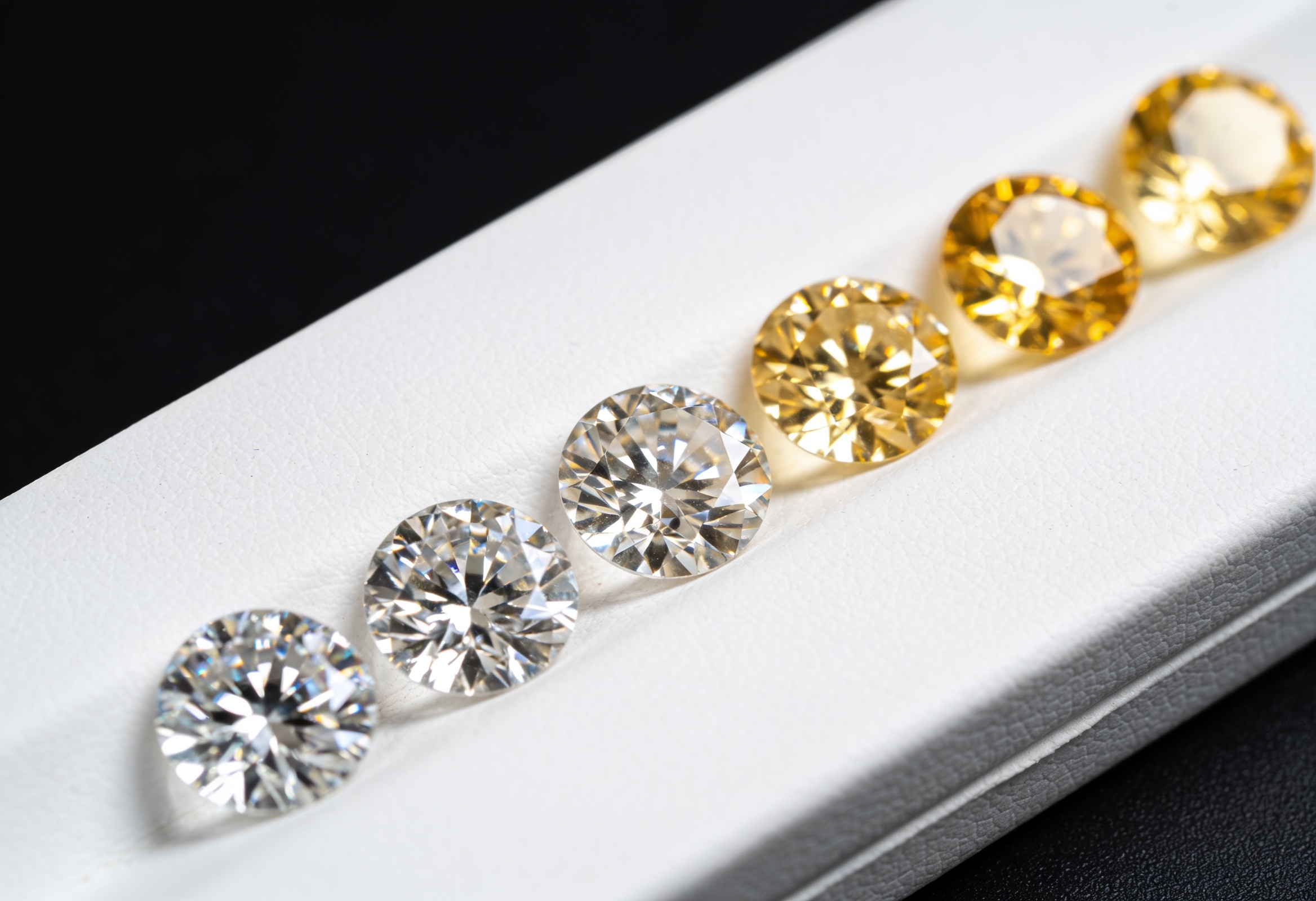 Diamond Colour Scale: D to Z Grades & Best Value 3 Diamonds being sorted by colour on a grading tray
