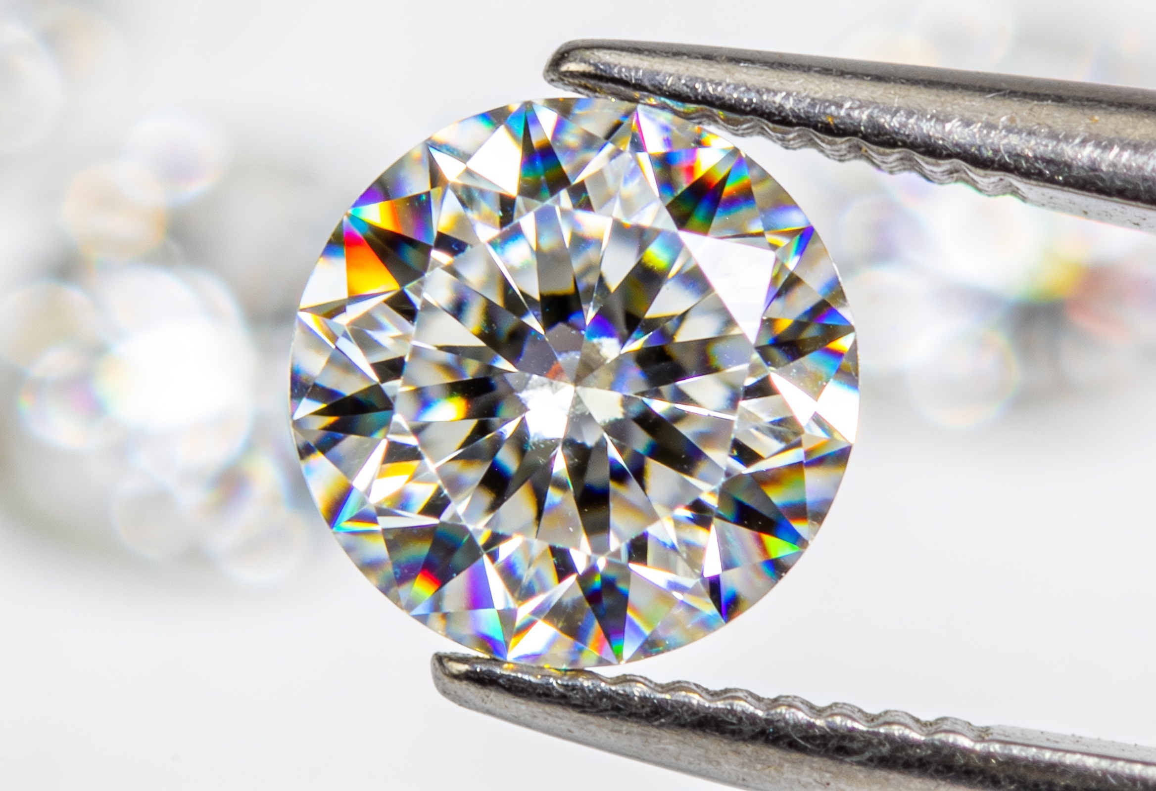 Moissanite vs Lab Grown Diamond 2 Macro view of a round brilliant moissanite showing rainbow fire