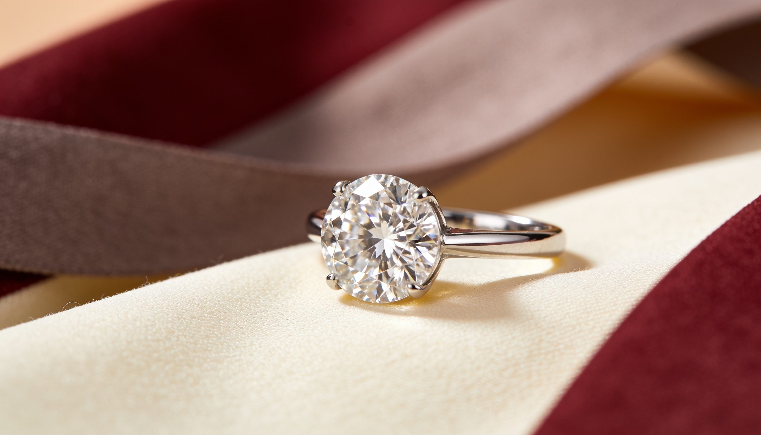 Modern brilliant cut lab grown diamond engagement ring on cream fabric, the mainstream lab grown diamond of today