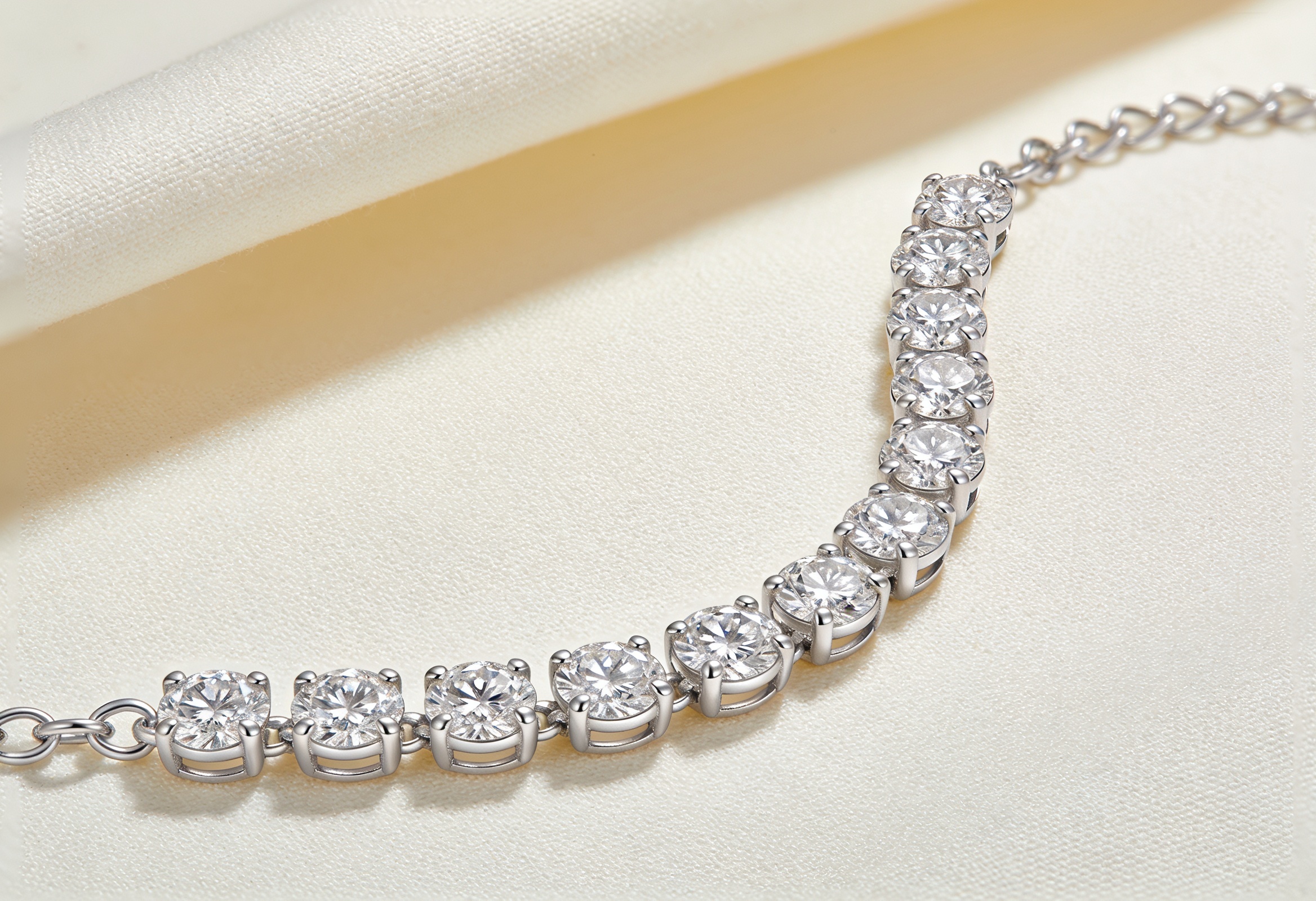 Lab Grown Diamond Tennis Bracelets in Canada 1 Lab grown diamond tennis bracelet in white gold curved on cream linen