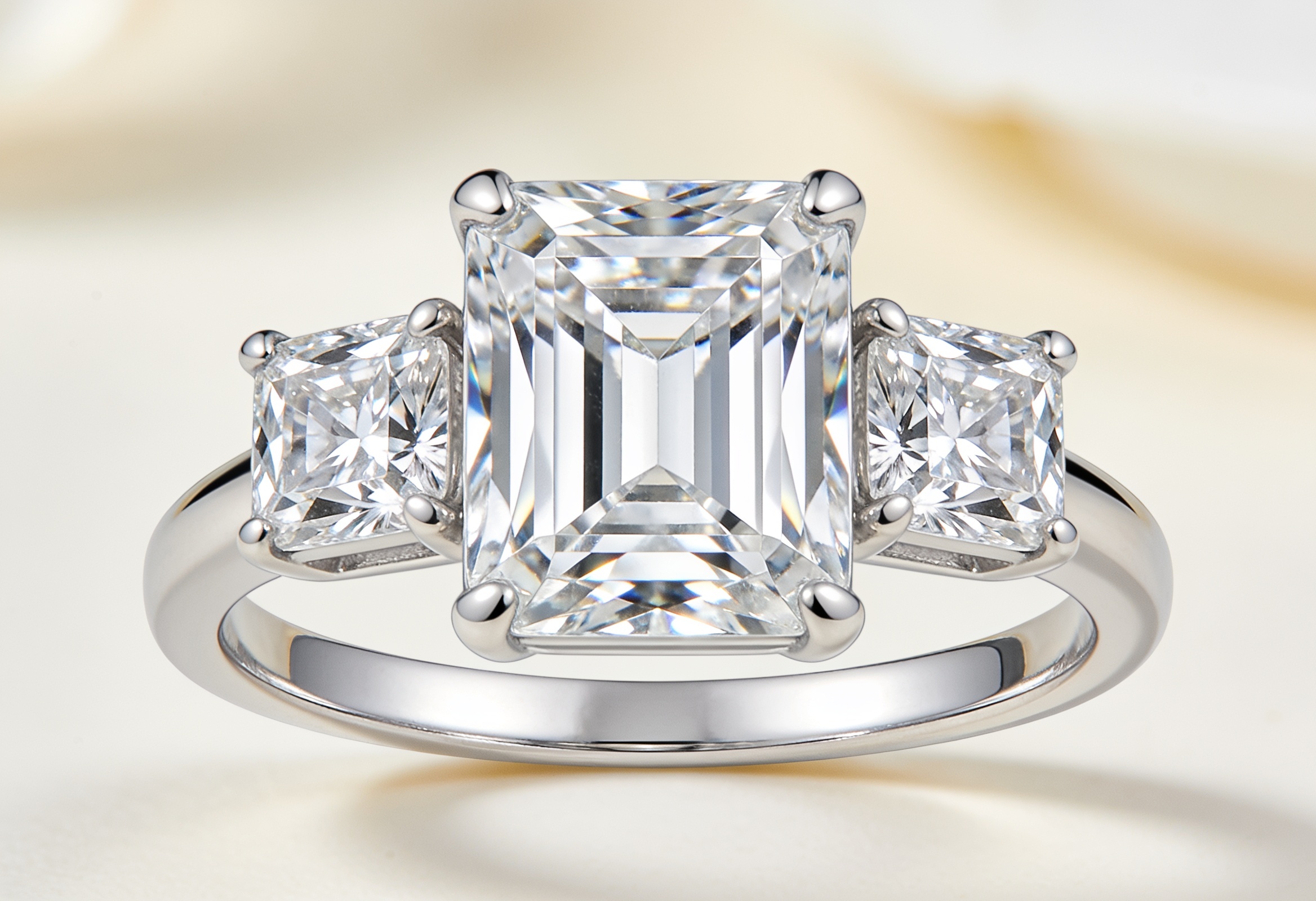 Three stone ring with an emerald cut centre and two emerald cut sides