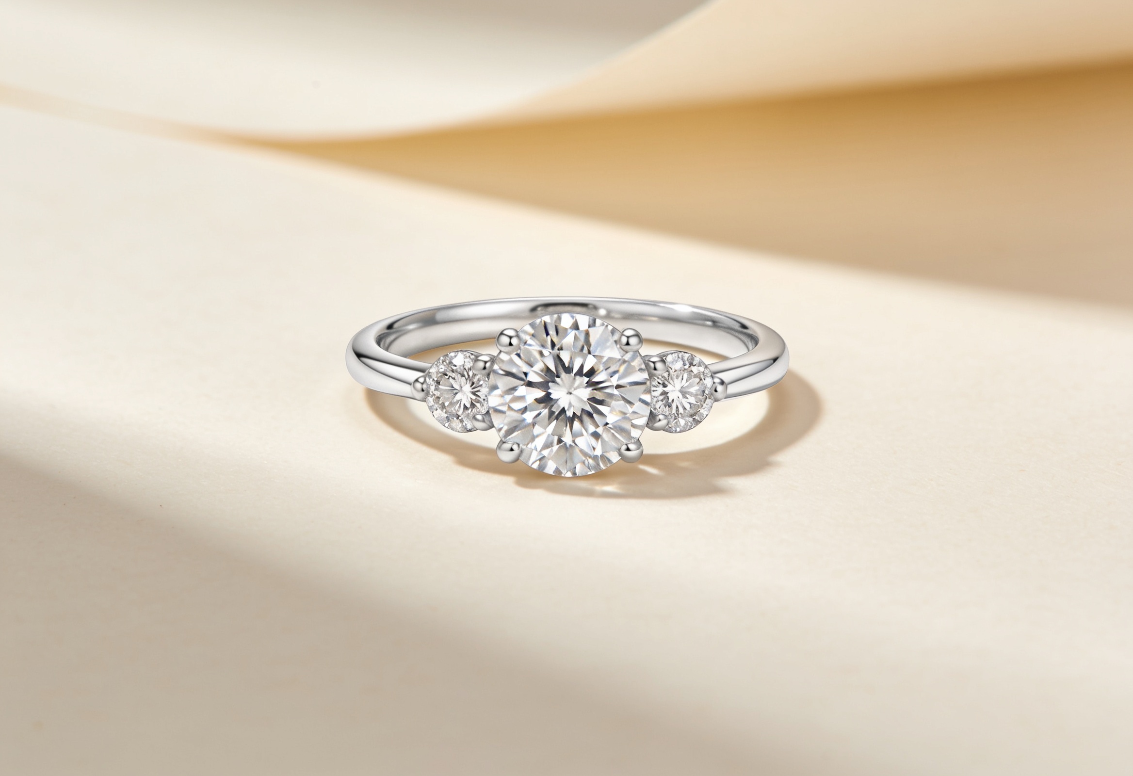 Three stone lab grown diamond engagement ring with a round centre and two side diamonds in white gold