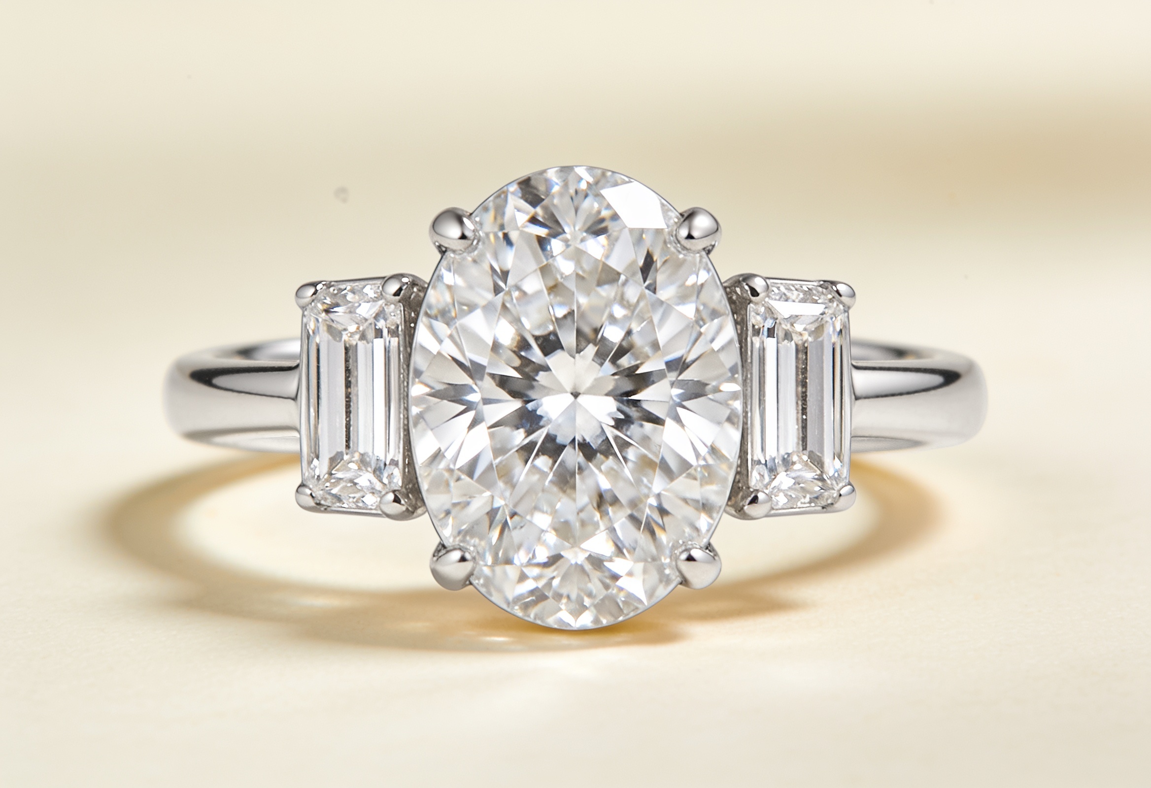 Three stone ring with an oval centre and tapered baguette sides